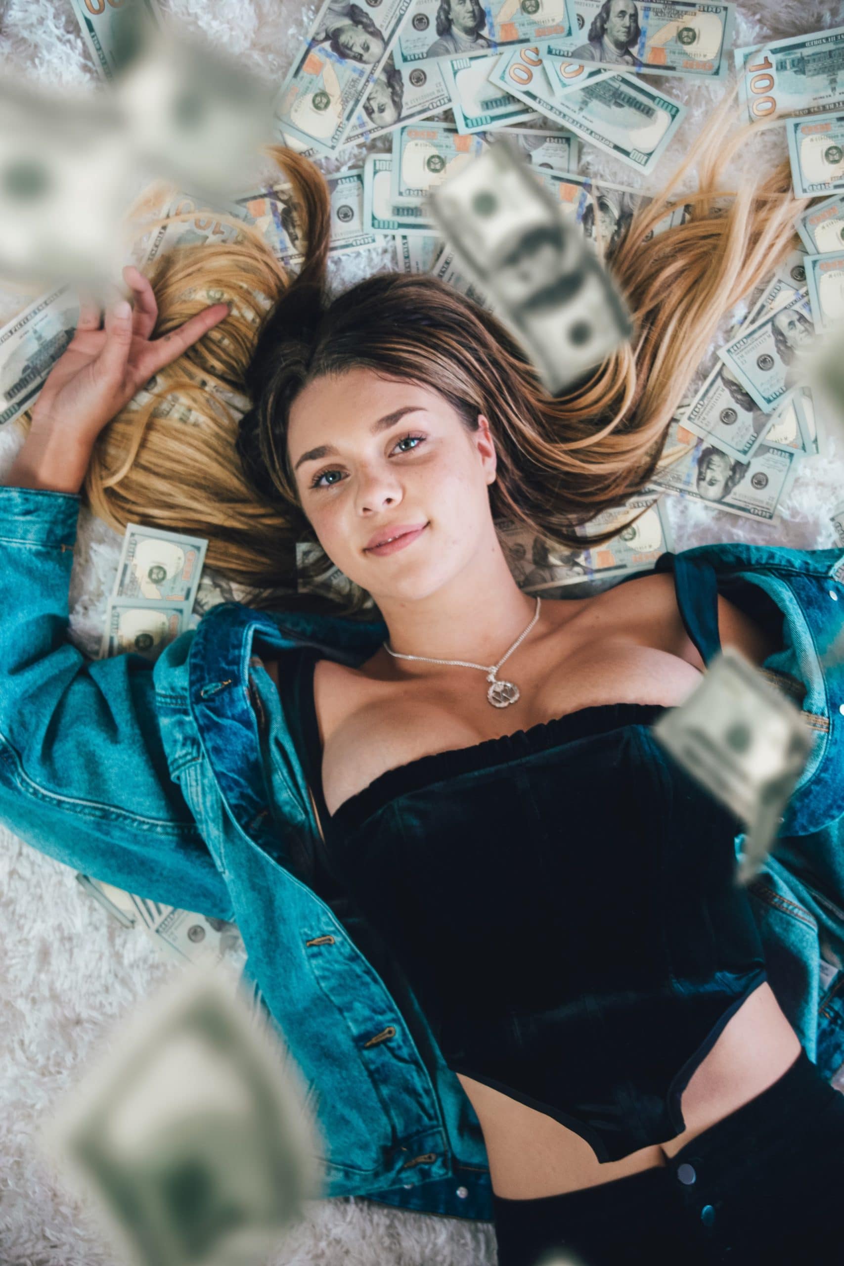 woman laying on money scaled