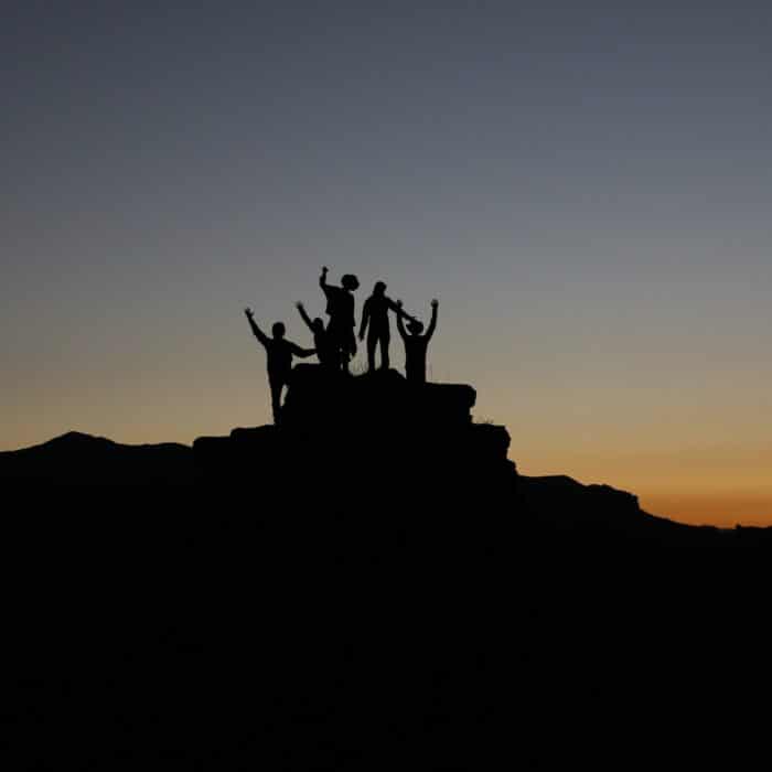 people on the top of a hill friends group