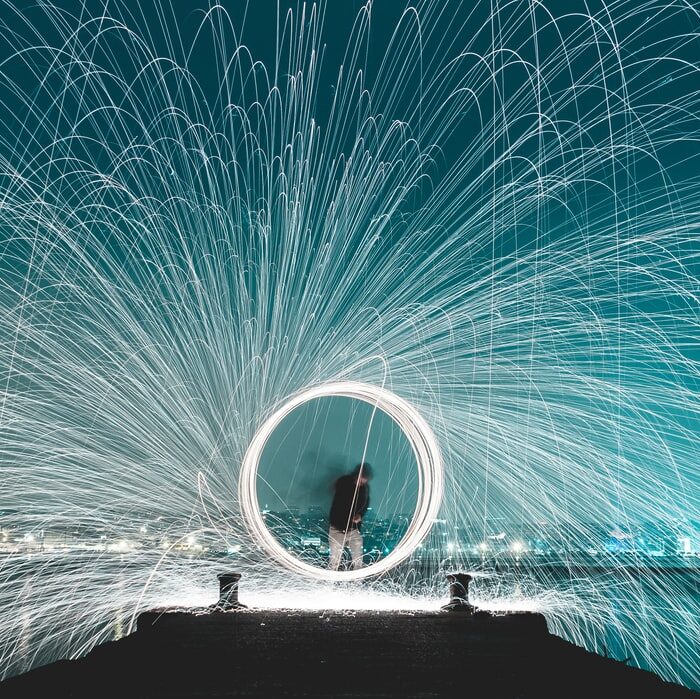 man making circle with sparklers