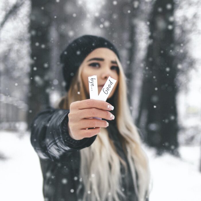 woman holding a goodbye slips of paper snow influencer