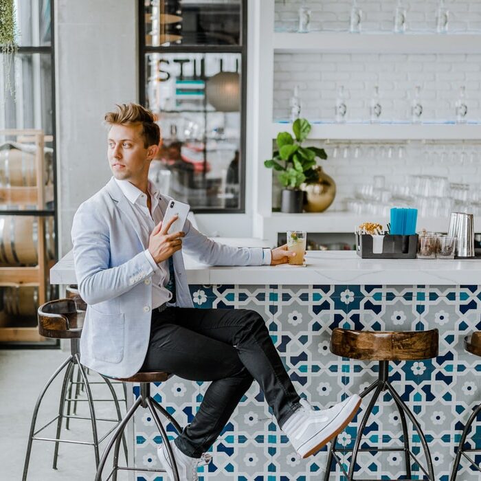 man sitting at a bar with a phone