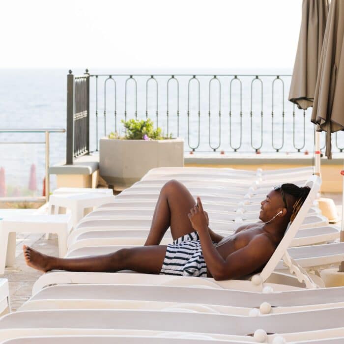 man relaxing by the pool on a chair