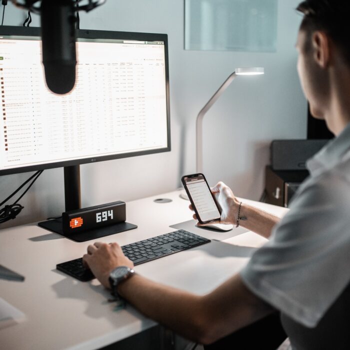 man on desktop with a mobile phone, camera, editor