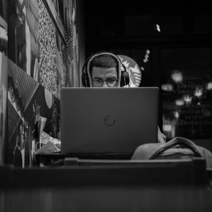man on laptop with headphones