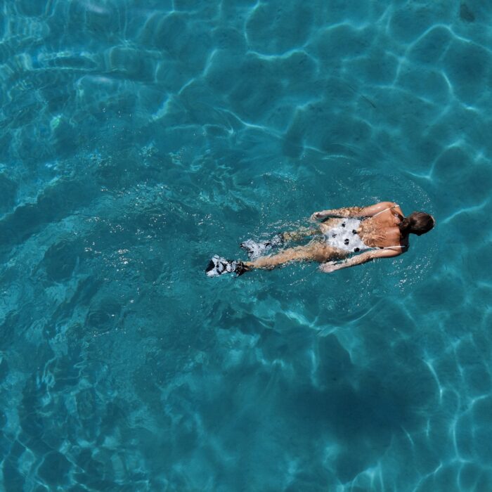 woman swimming in blue water