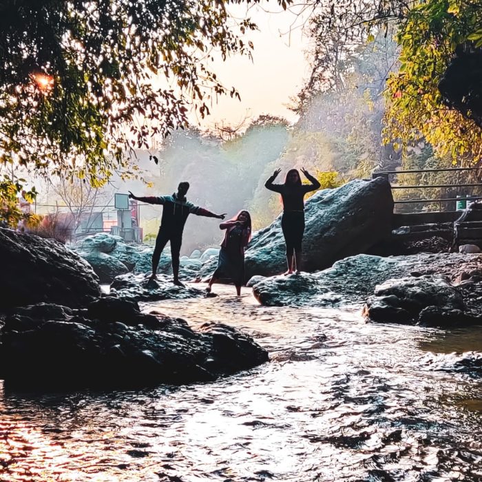 three people at the end of a creek