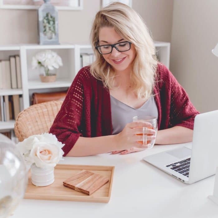 woman on laptop drinking tea planning