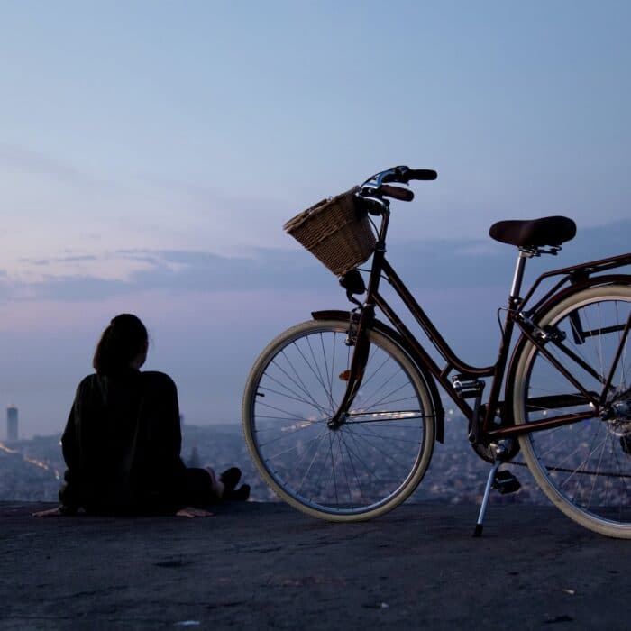 woman influencer with bike with city skyline