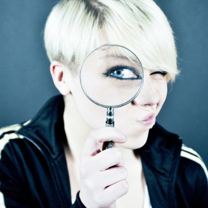 woman holding magnifying glass