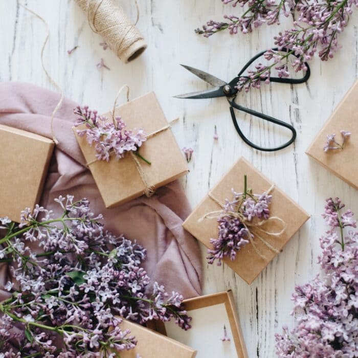 presents with flowers and scissors on the ground purple flowers