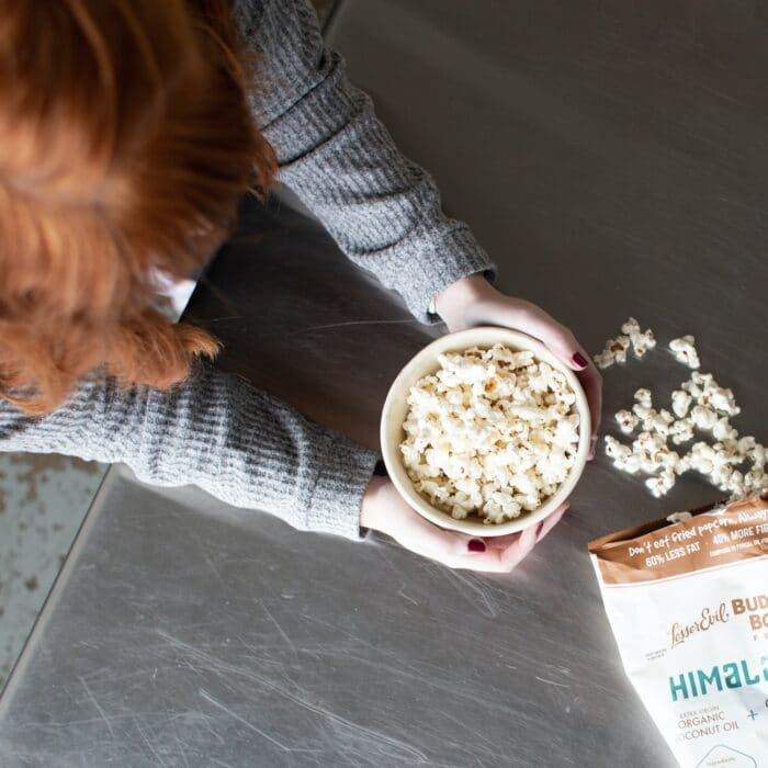 woman with popcorn in a bowl