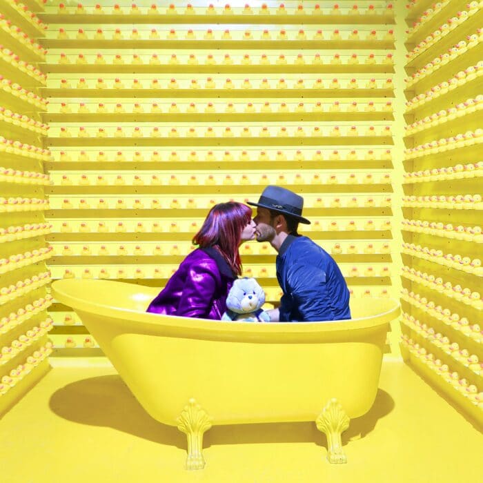 ducks kissing couple in bathtub yellow