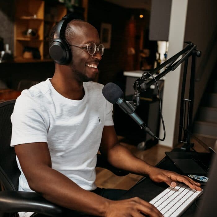 man with mic and headset on a computer