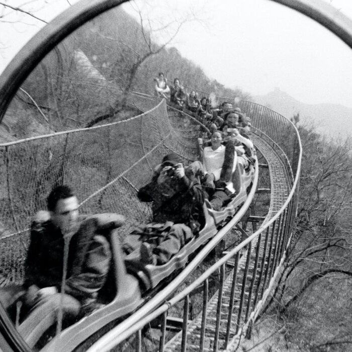 people on a roller coaster with a mirror