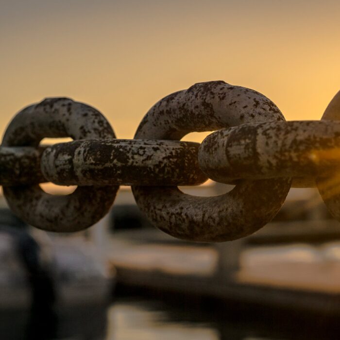 chain link sunlight with boat in background
