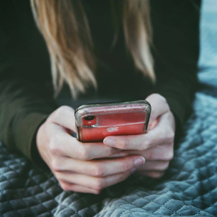 woman on mobile phone in bed