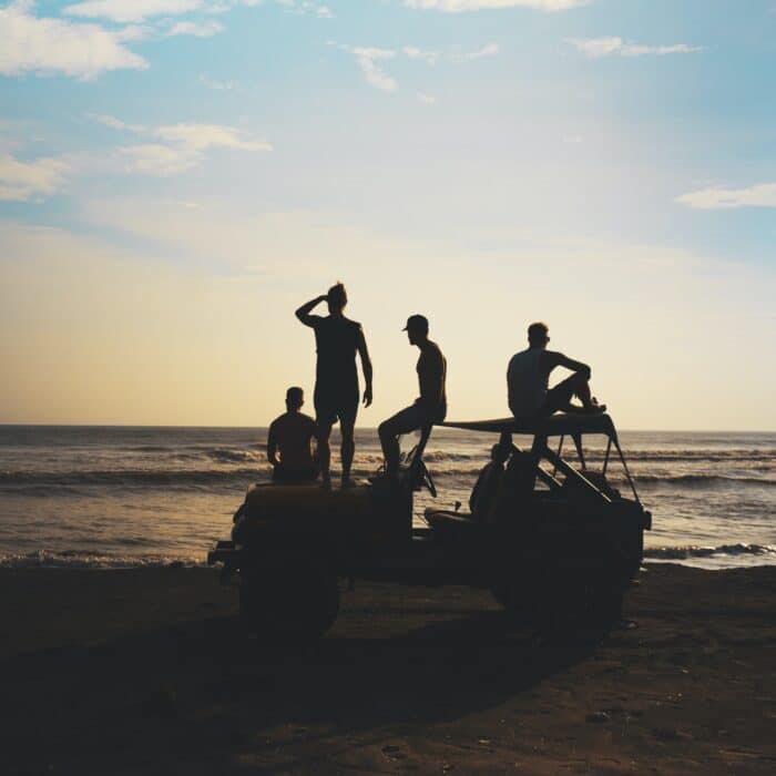 jeep with friends group on a beach