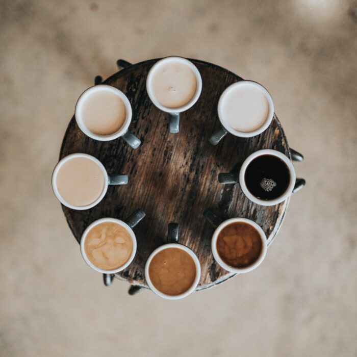 several coffees in a circle with various amounts of cream