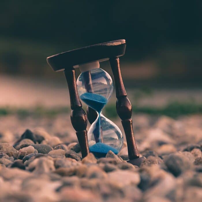 hourglass in gravel time clock