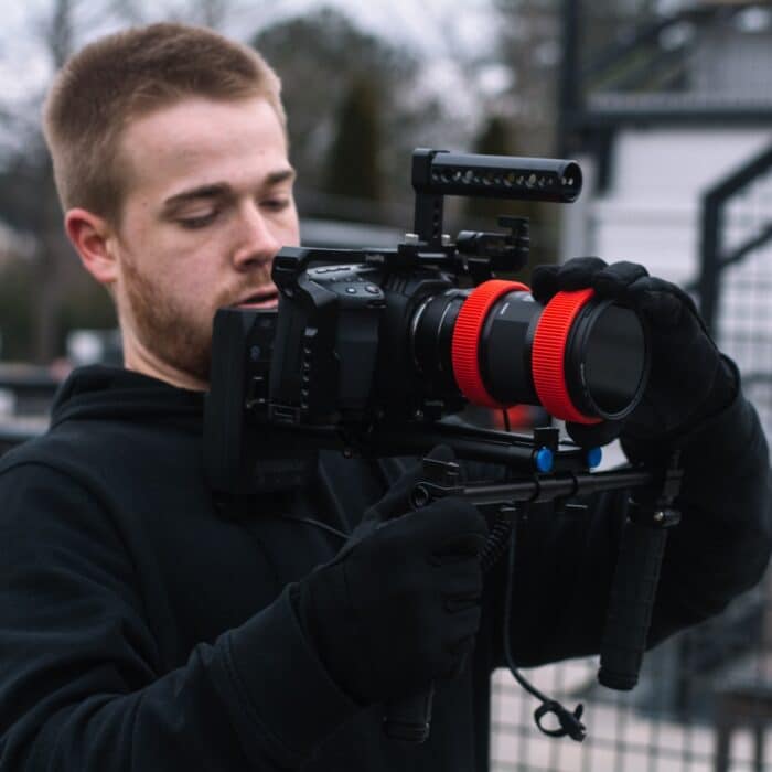 man holding a video camera photographer videographer