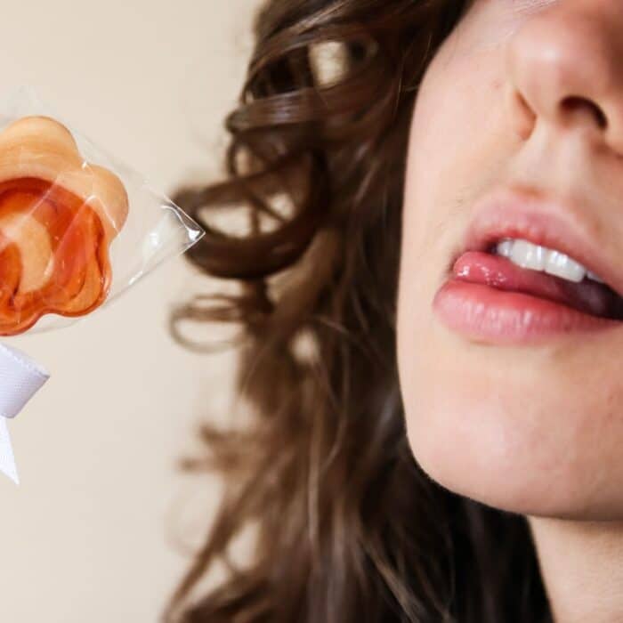 woman licking lollipop