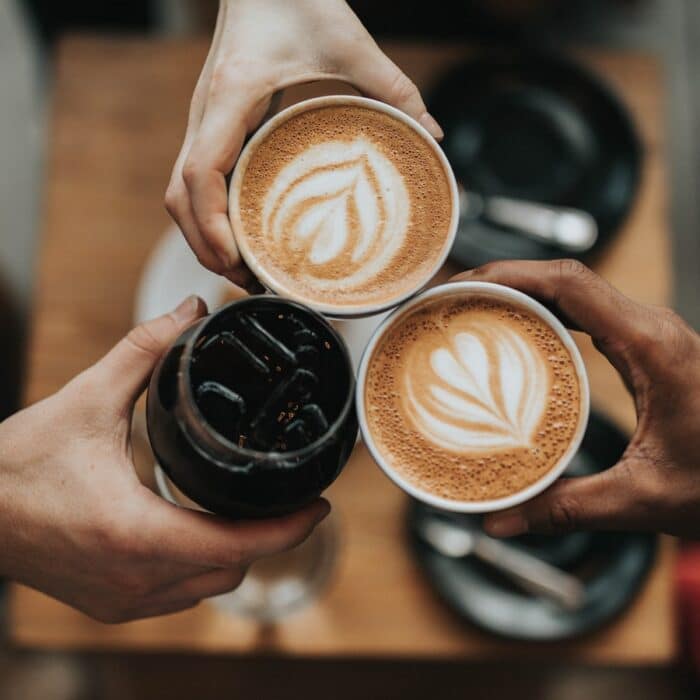 three people sharing coffee together