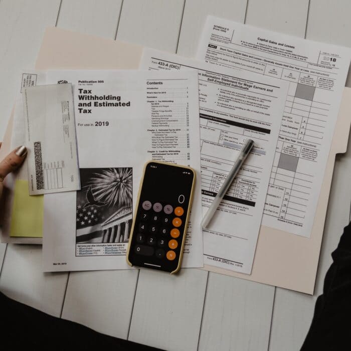 woman sitting on floor doing her taxes