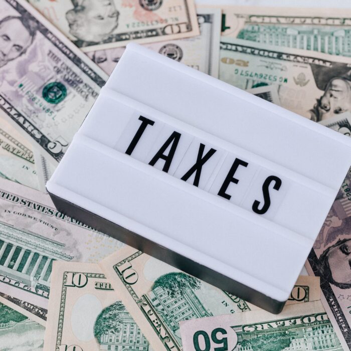 taxes sign sitting on cash