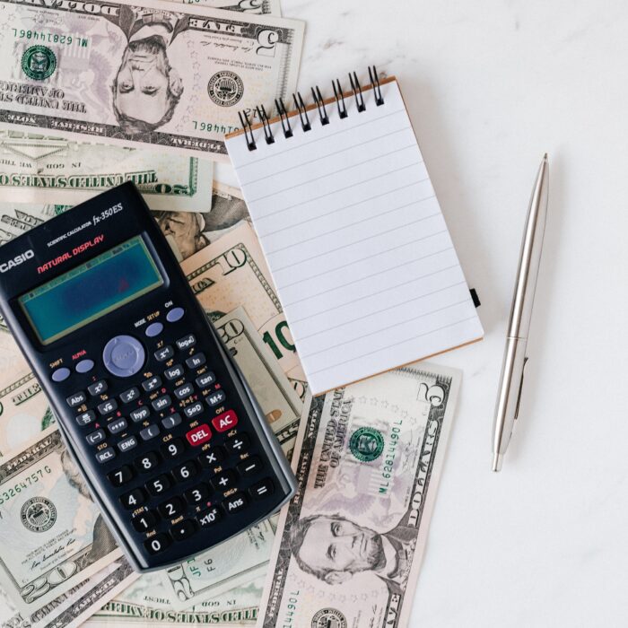 calculator on money and cash and notebook