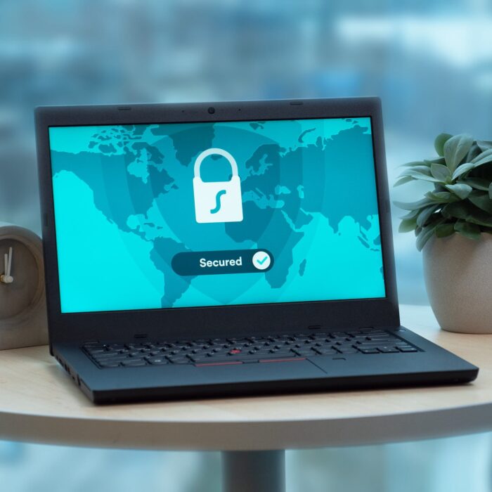 vpn on desk laptop with wooden clock