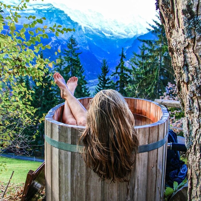woman in a hot tub in mountains