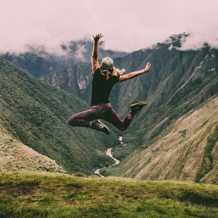 woman jumping on mountain