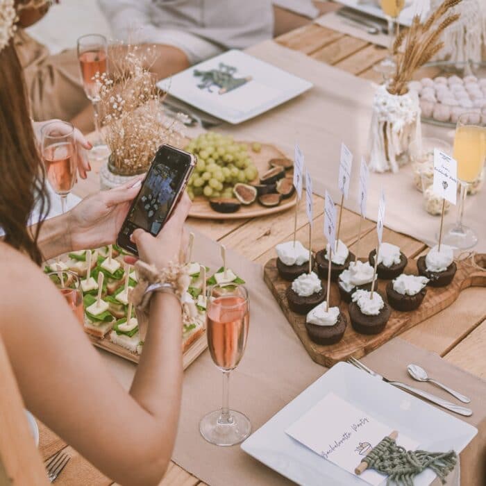 woman taking pictures of cupcakes