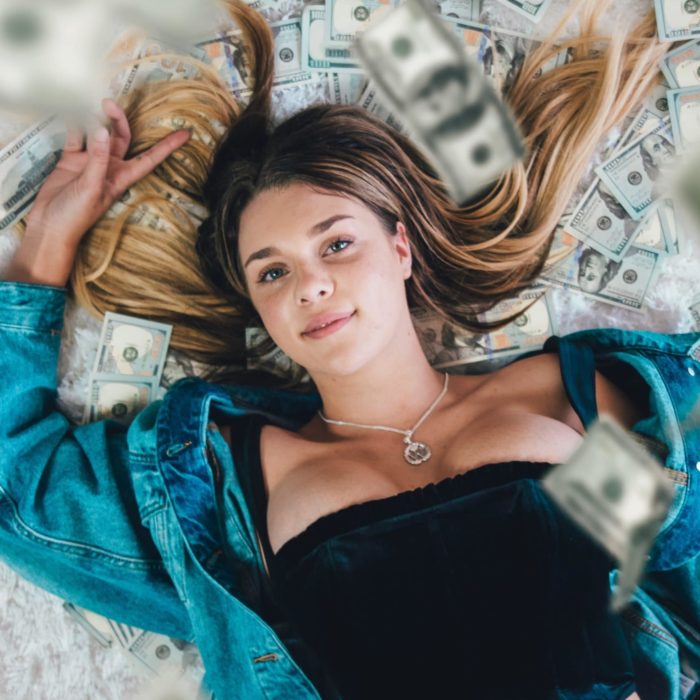 woman laying on money