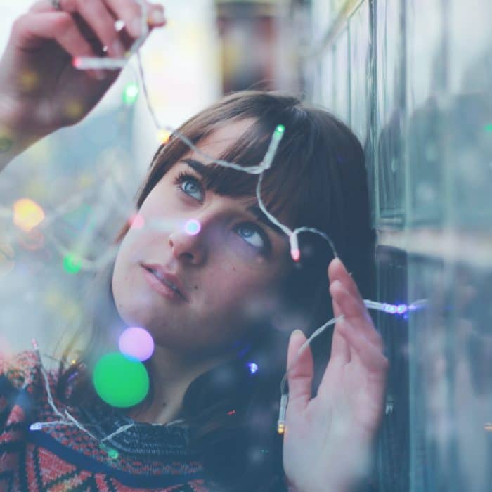 woman looking at twinkle lights