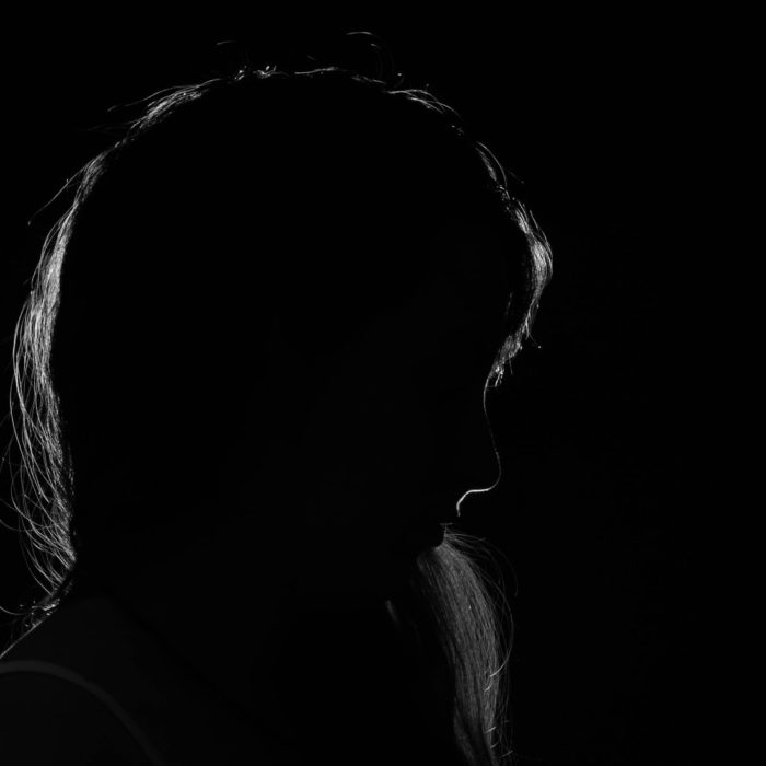 silhouette of womans head on a black background