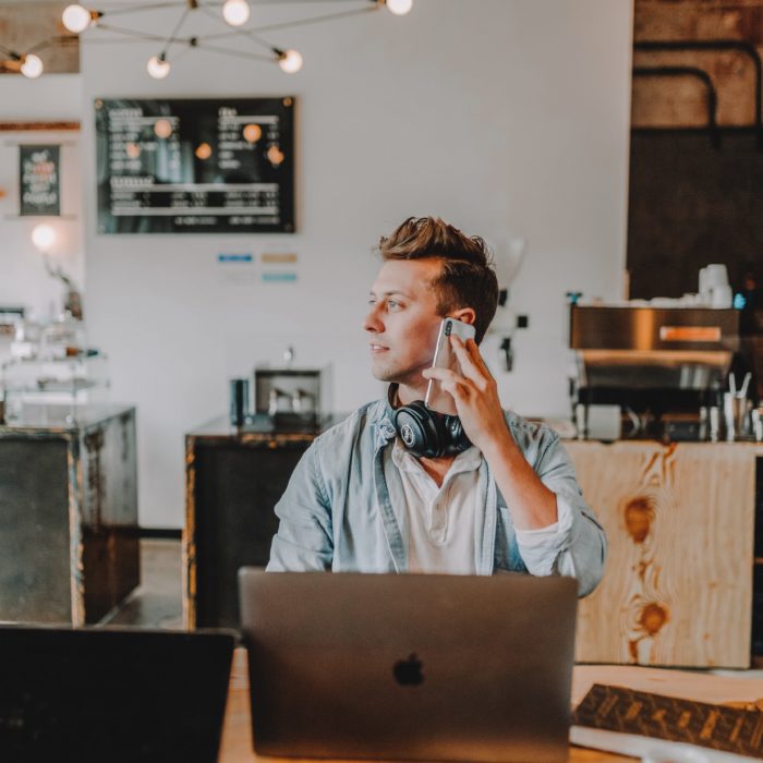 man on phone using computer