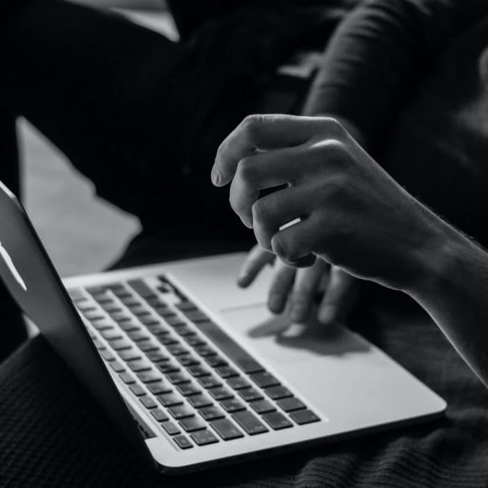 black and white picture of person on computer