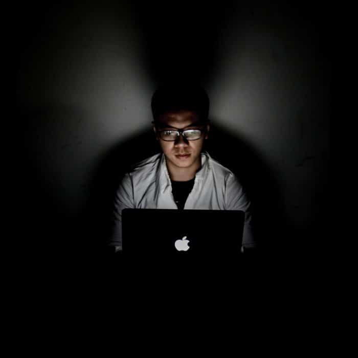 man on laptop in the dark