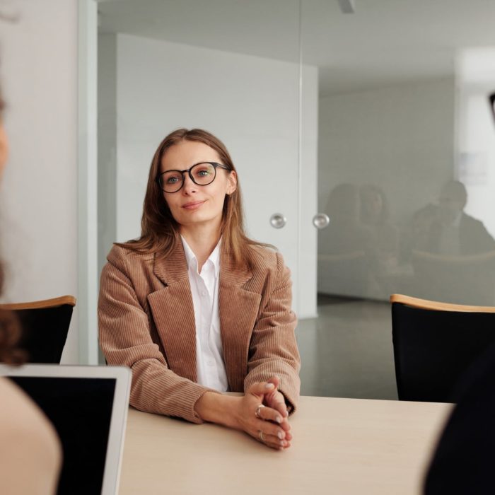 woman interviews two individuals