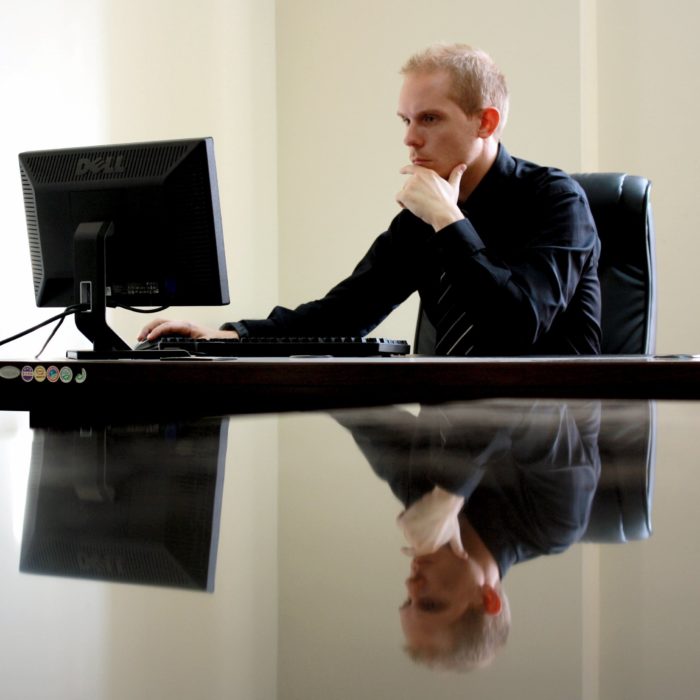 man in black working on desktop