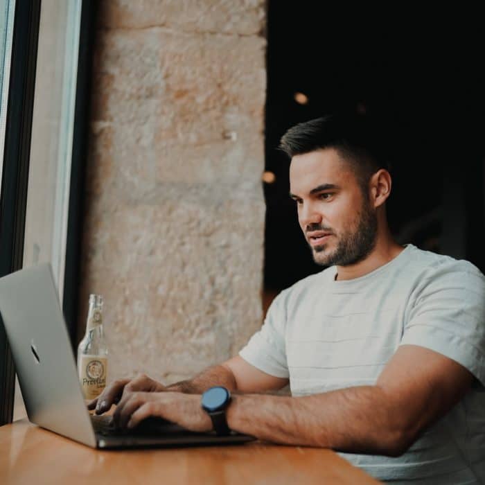 man with laptop in shop