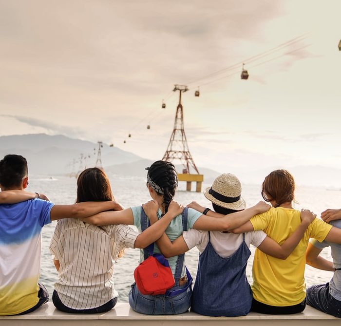 friends on a bench at beach