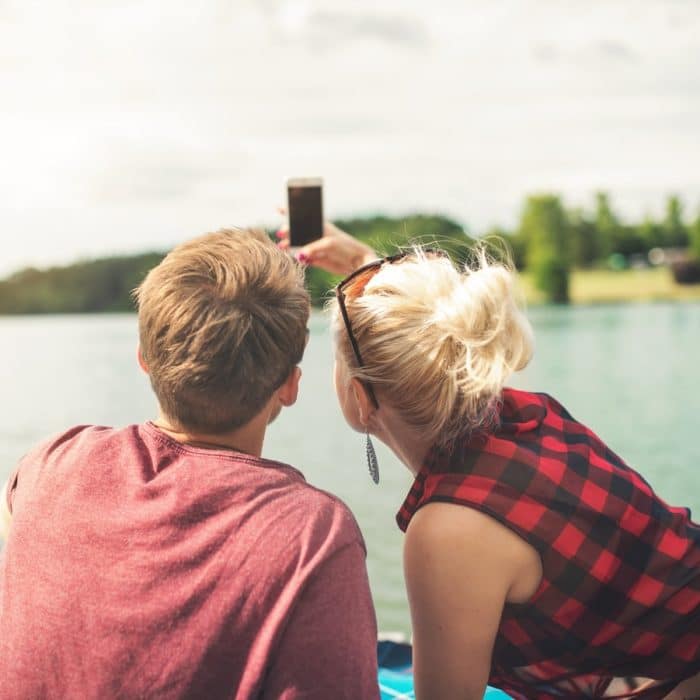 man and woman looking at phone