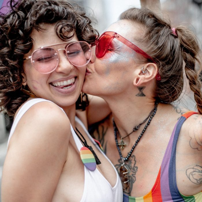 woman kissing another woman's cheek