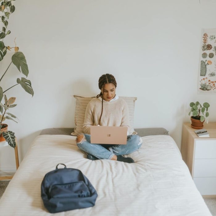 woman sitting in bed on laptop