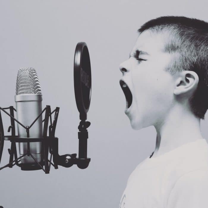 boy screaming into mic