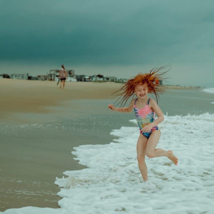 girl running through waves