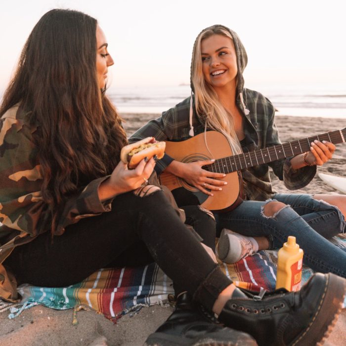 girls singing on beach