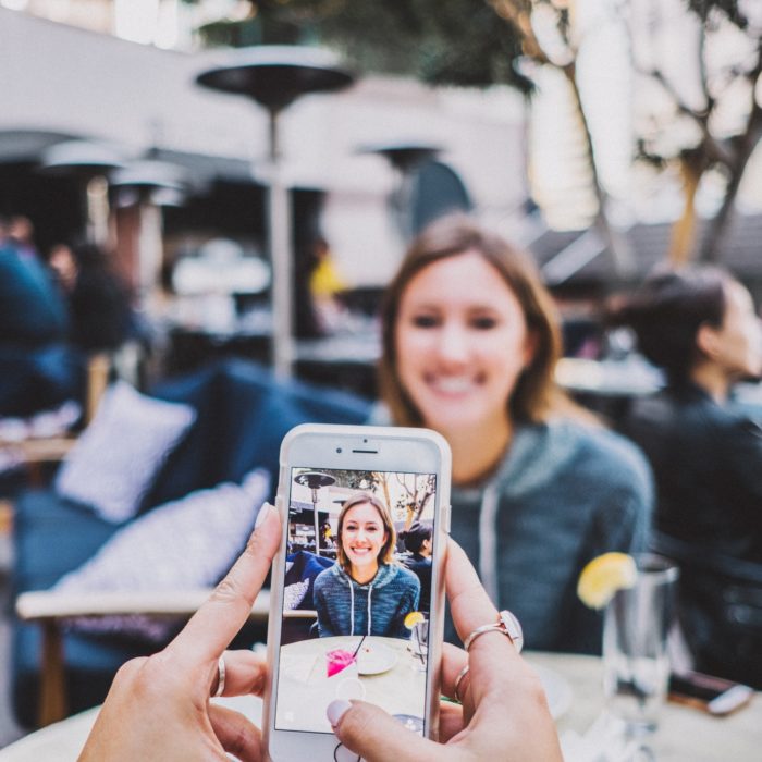 person taking a photo of another person